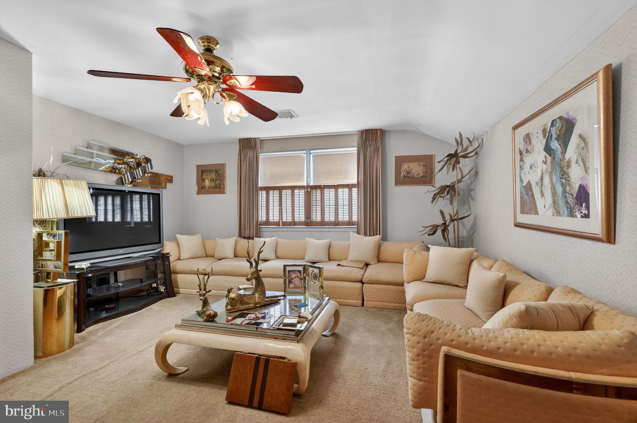 1912 Cobden Road Glenside, PA 19038 - Photo 13 of 30 a living room with furniture ceiling fan and a rug