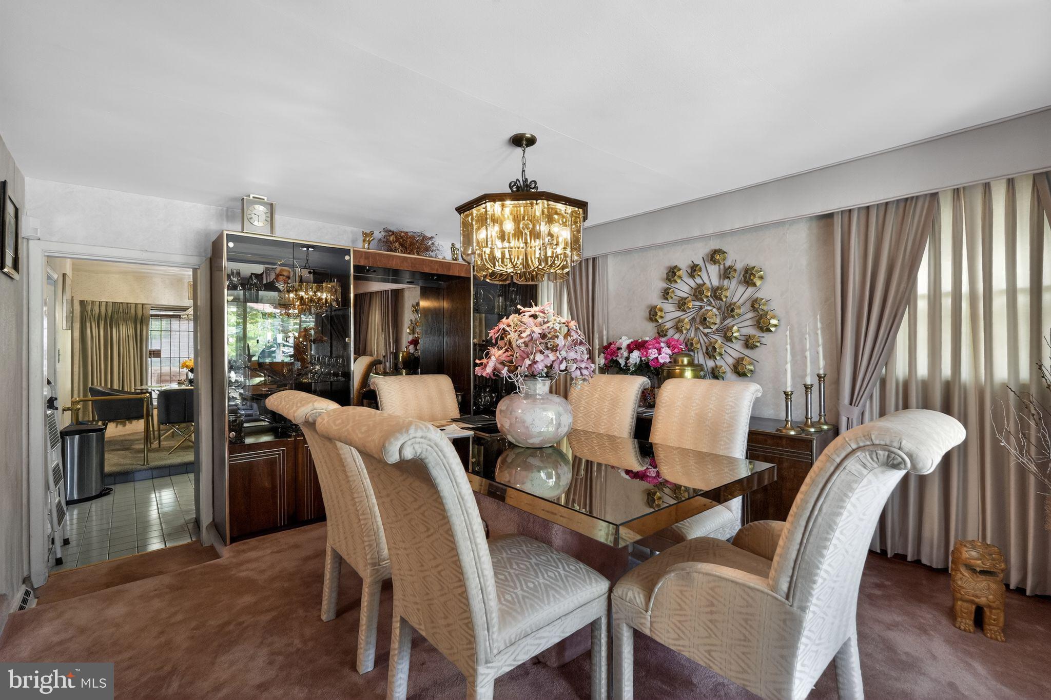 1912 Cobden Road Glenside, PA 19038 - Photo 7 of 30 a dining room with furniture a chandelier and wooden floor