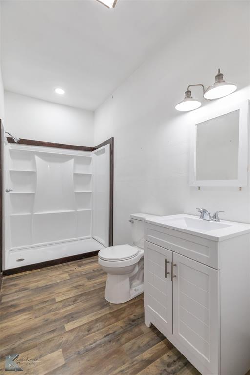 344 Southwest Ave A Hamlin, TX 79520 - Photo 16 of 19 a bathroom with a sink toilet and vanity