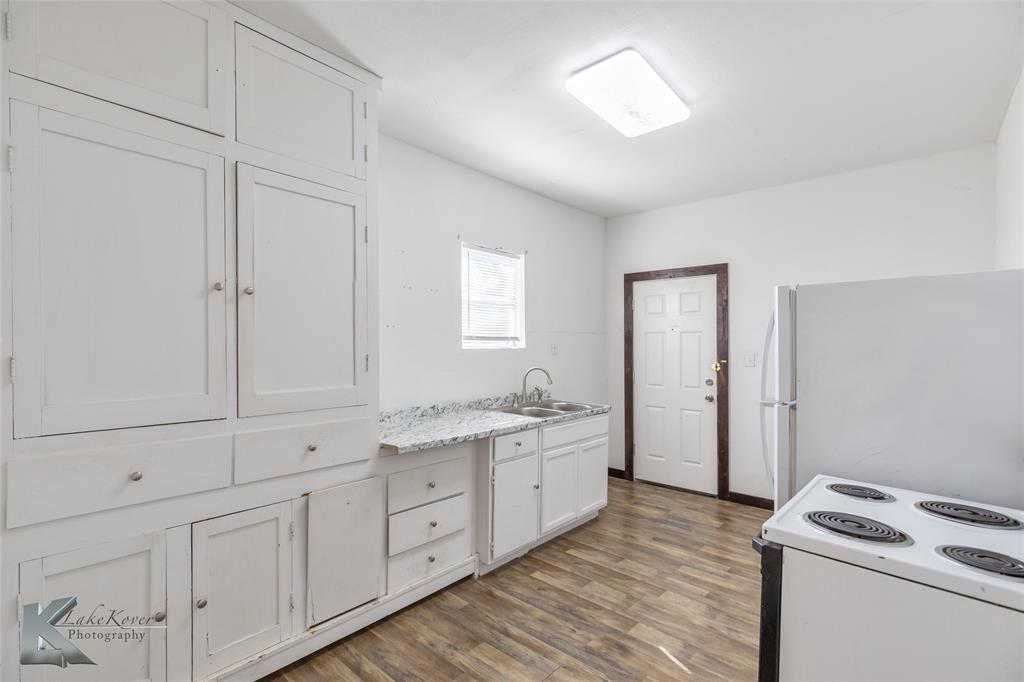 344 Southwest Ave A Hamlin, TX 79520 - Photo 5 of 19 a kitchen with white cabinets and sink