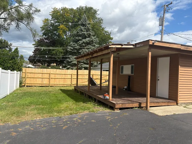 a view of a tiny house with wooden fence