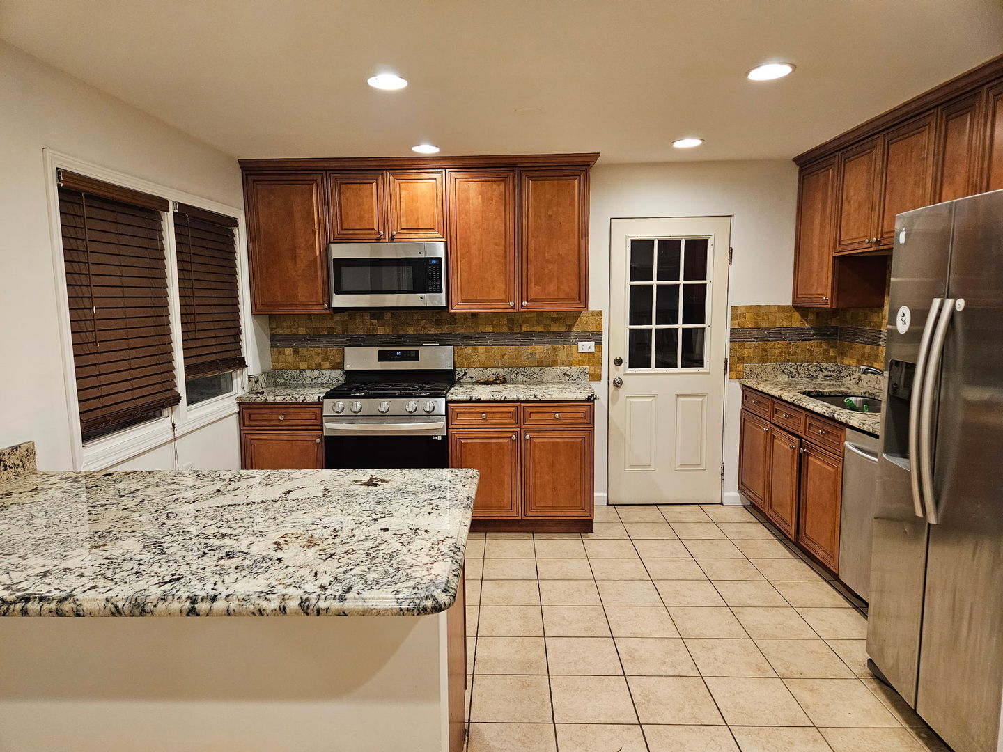 751 North Northwest Highway Park Ridge, IL 60068 - Photo 5 of 25 a kitchen with stainless steel appliances granite countertop a stove top oven a sink a counter top space and cabinets