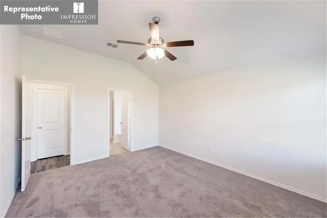 a view of empty room with ceiling fan