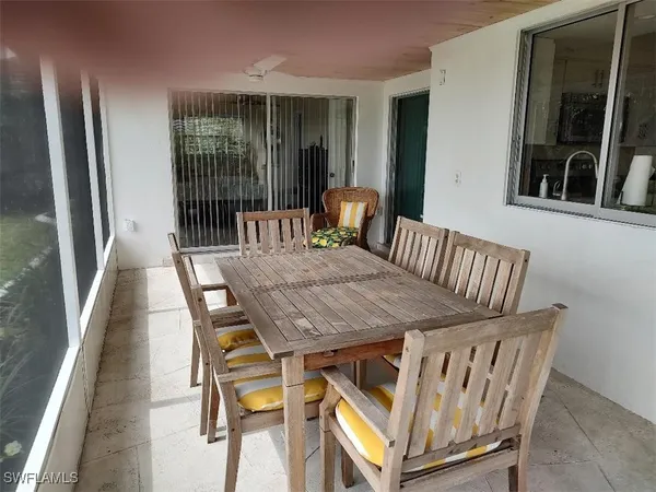 a view of a dining room with furniture and window