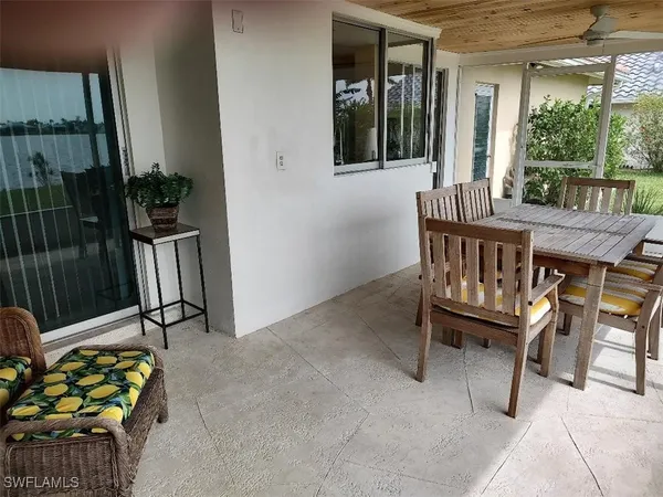 a view of a patio with table and chairs