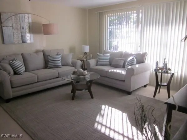 a living room with furniture and a window