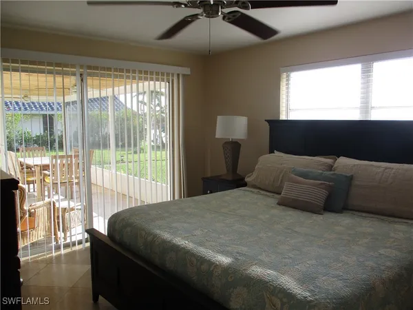 a bedroom with a bed and a lamp