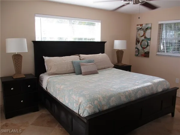 a bedroom with a bed and window