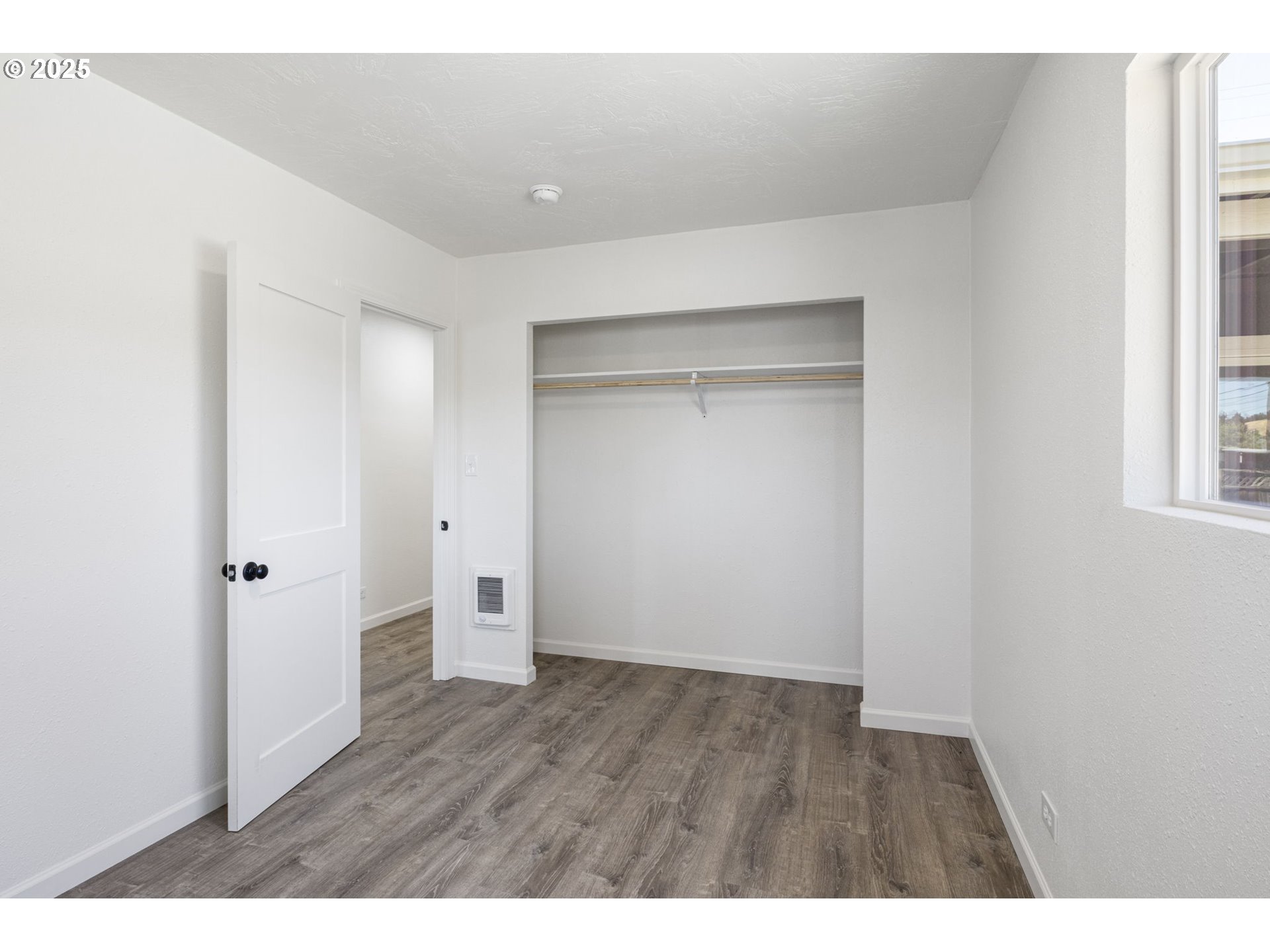 514 East 2nd Avenue Riddle, OR 97469 - Photo 11 of 16 a view of an empty room with wooden floor and a window