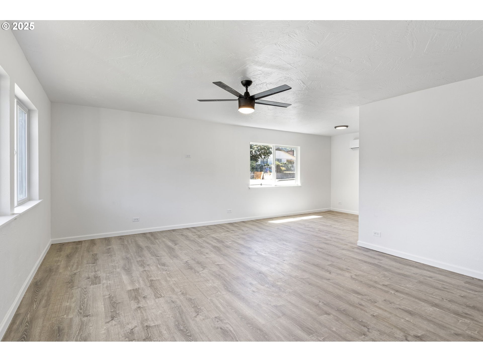 514 East 2nd Avenue Riddle, OR 97469 - Photo 4 of 16 a view of an empty room with a window and wooden floor