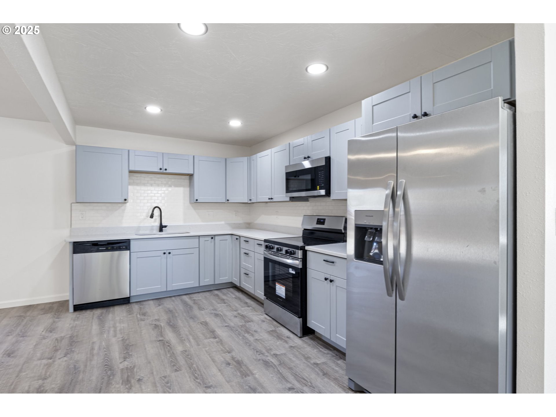 514 East 2nd Avenue Riddle, OR 97469 - Photo 7 of 16 a kitchen with a refrigerator sink and cabinets