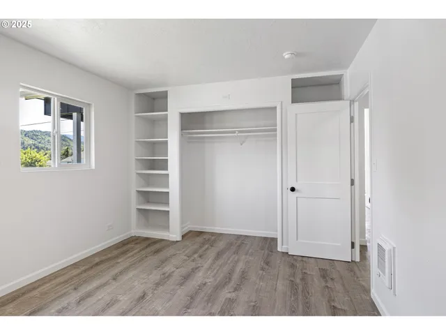 a view of an empty room with a closet area