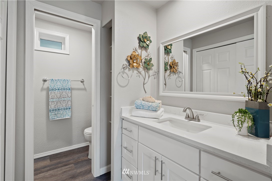 7579 Old Redmond Road, Unit 4 Redmond, WA 98052 - Photo 13 of 21 a bathroom with a granite countertop sink a toilet and a mirror