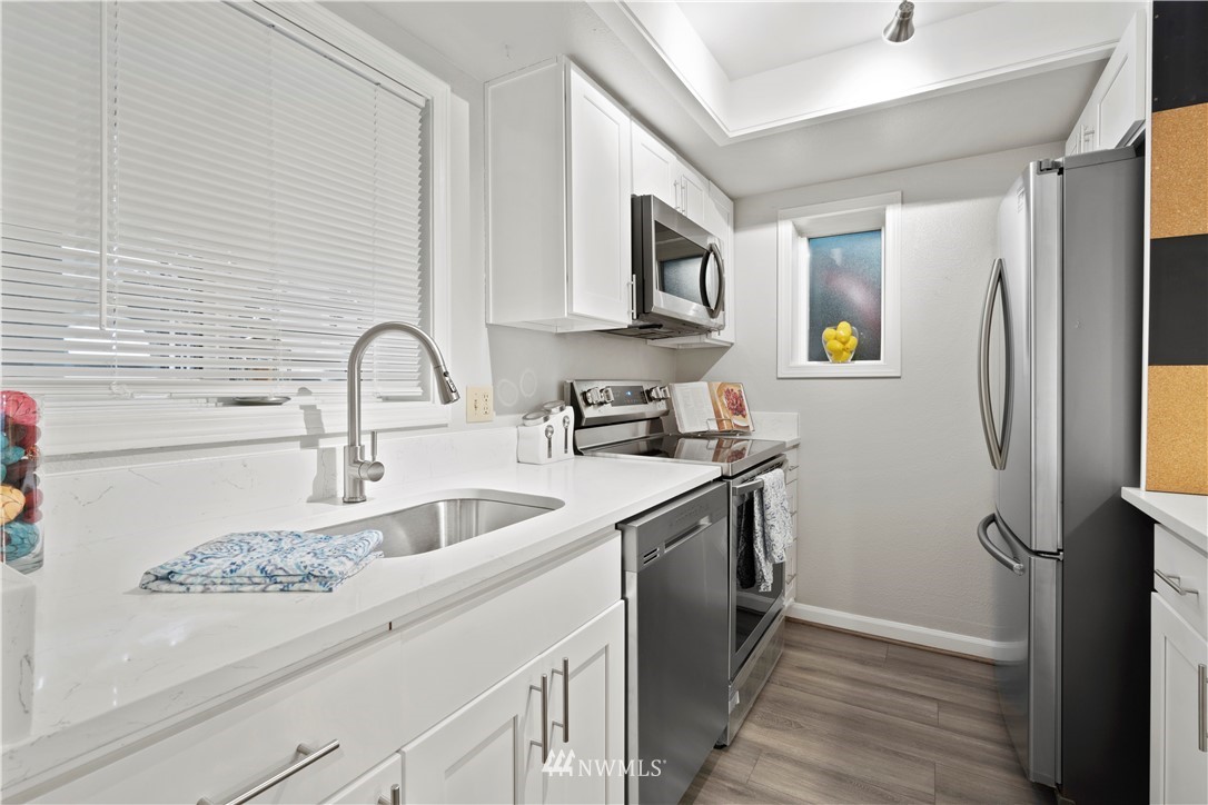 7579 Old Redmond Road, Unit 4 Redmond, WA 98052 - Photo 7 of 21 a kitchen with stainless steel appliances granite countertop a sink and a refrigerator