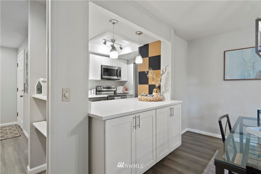 7579 Old Redmond Road, Unit 4 Redmond, WA 98052 - Photo 8 of 21 a kitchen with kitchen island granite countertop a sink cabinets a refrigerator and a stove