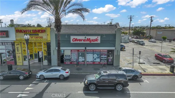 a view of a cars park in front of a building