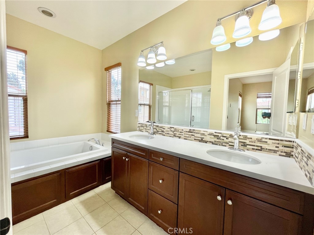 65 Sacred Path Irvine, CA 92618 - Photo 13 of 22 a bathroom with a tub sink and mirror