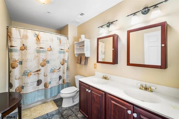 a bedroom with two beds and a chandelier