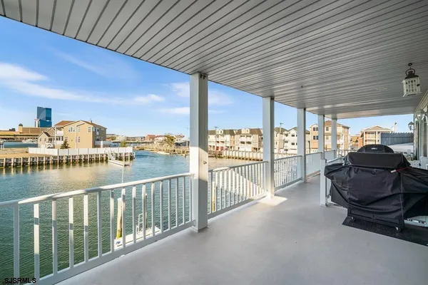 a view of a lake with a table and chairs