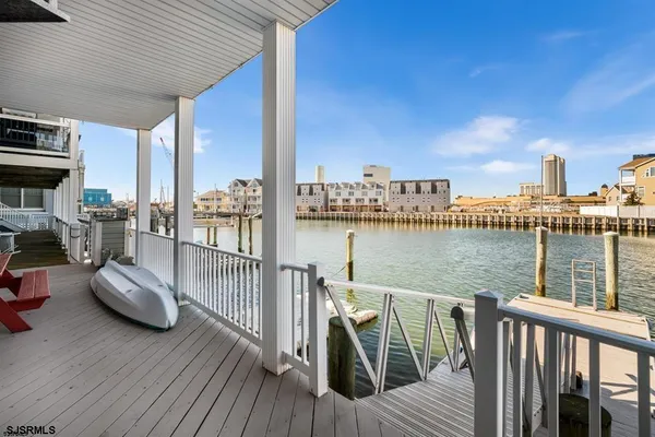 a kitchen with stainless steel appliances granite countertop wooden cabinets a stove a sink and dishwasher with wooden floor