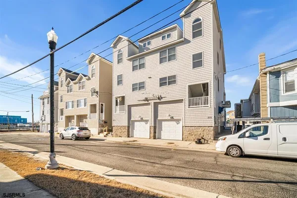 a kitchen with stainless steel appliances granite countertop a stove a sink dishwasher and a microwave oven with wooden floor