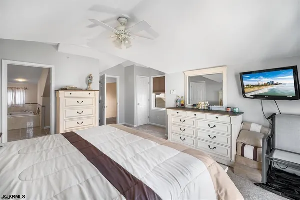 a bathroom with a sink toilet a mirror and shower curtain