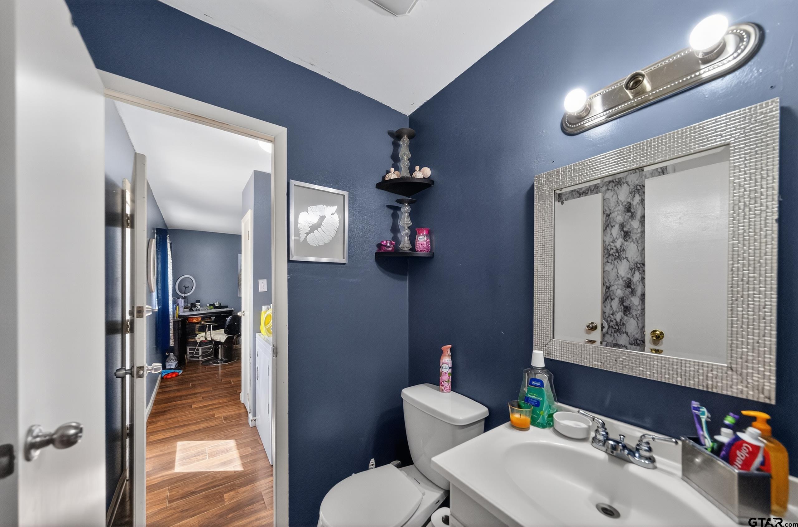 3165 Jackson Avenue Tyler, TX 75705 - Photo 11 of 24 a bathroom with a sink and a mirror