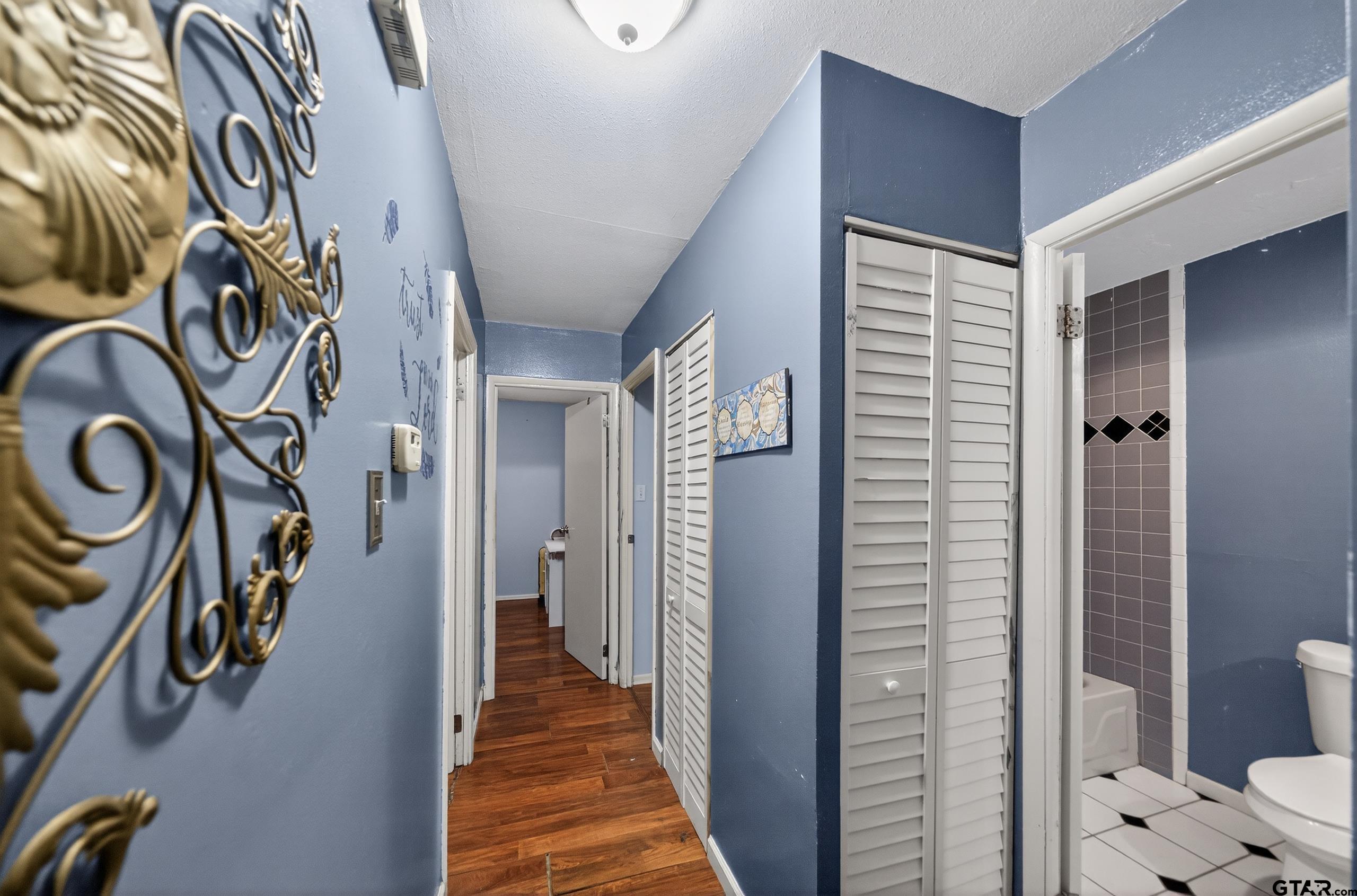 3165 Jackson Avenue Tyler, TX 75705 - Photo 13 of 24 a view of a hallway with paintings on the wall