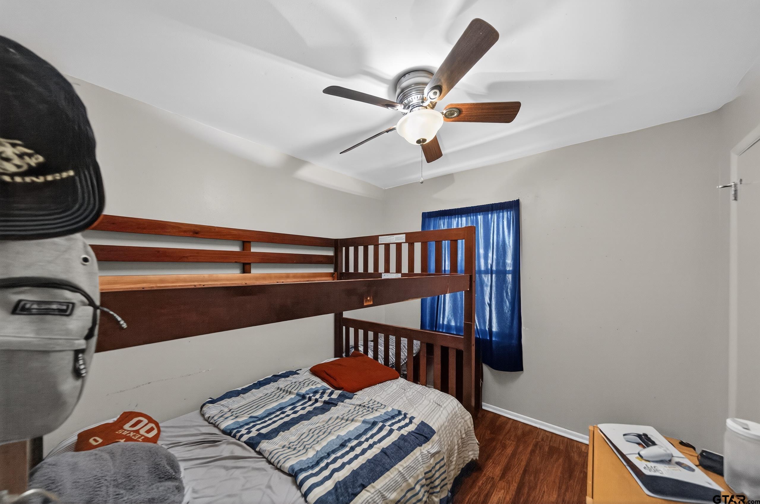 3165 Jackson Avenue Tyler, TX 75705 - Photo 15 of 24 a bedroom with a bed and a chandelier