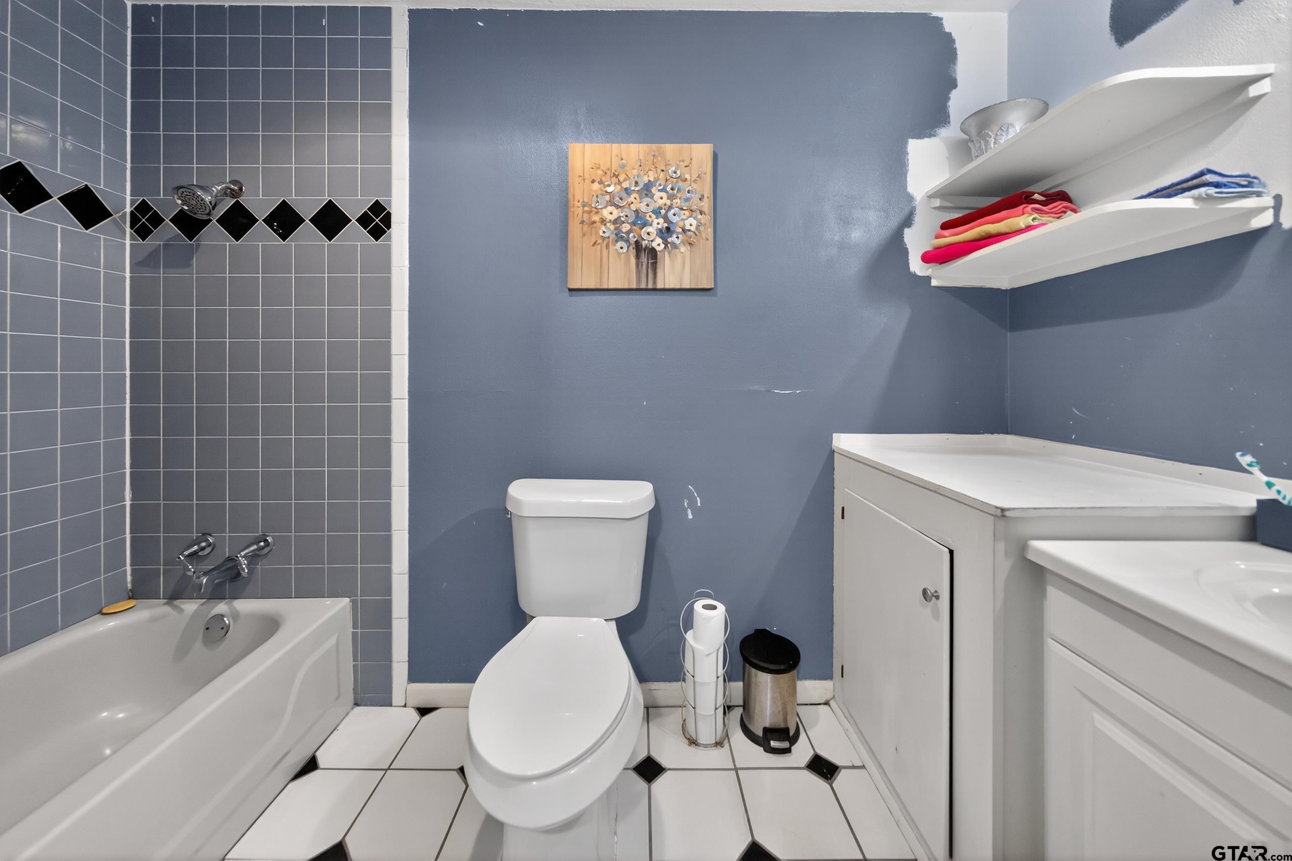 3165 Jackson Avenue Tyler, TX 75705 - Photo 18 of 24 a bathroom with a toilet and a bathtub