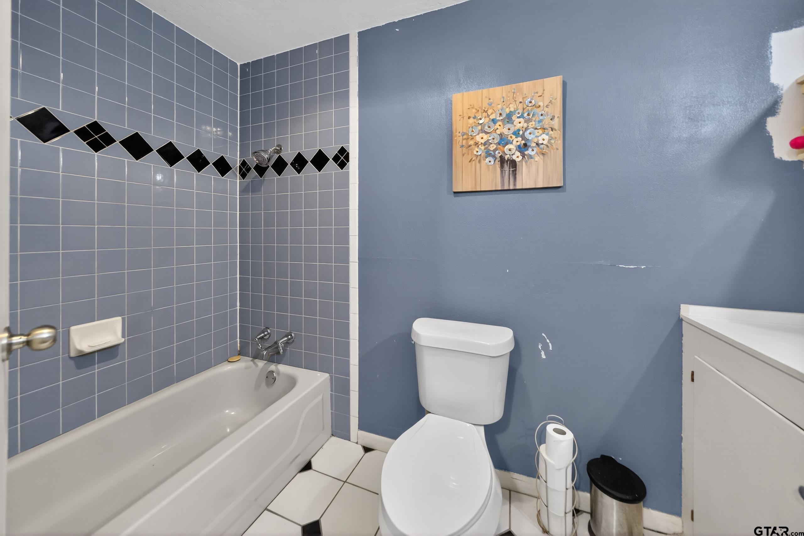 3165 Jackson Avenue Tyler, TX 75705 - Photo 19 of 24 a white toilet sitting next to a bathroom sink and tub