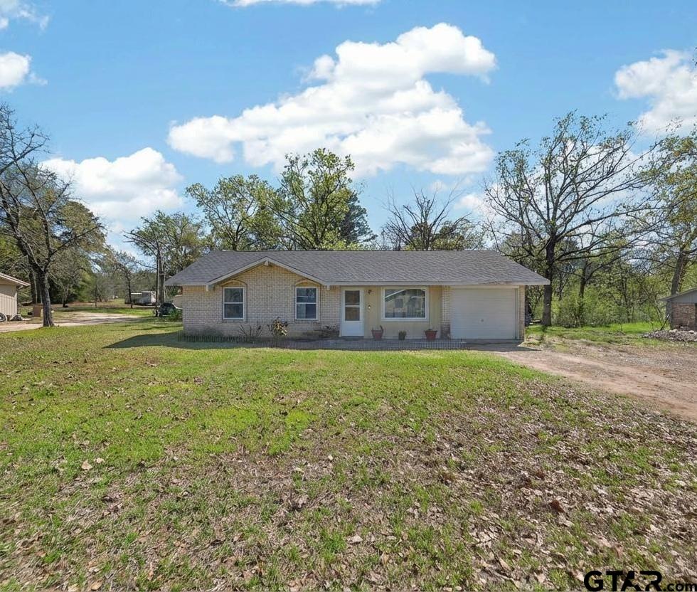 3165 Jackson Avenue Tyler, TX 75705 - Photo 2 of 24 a aerial view of house with yard and trees in the background