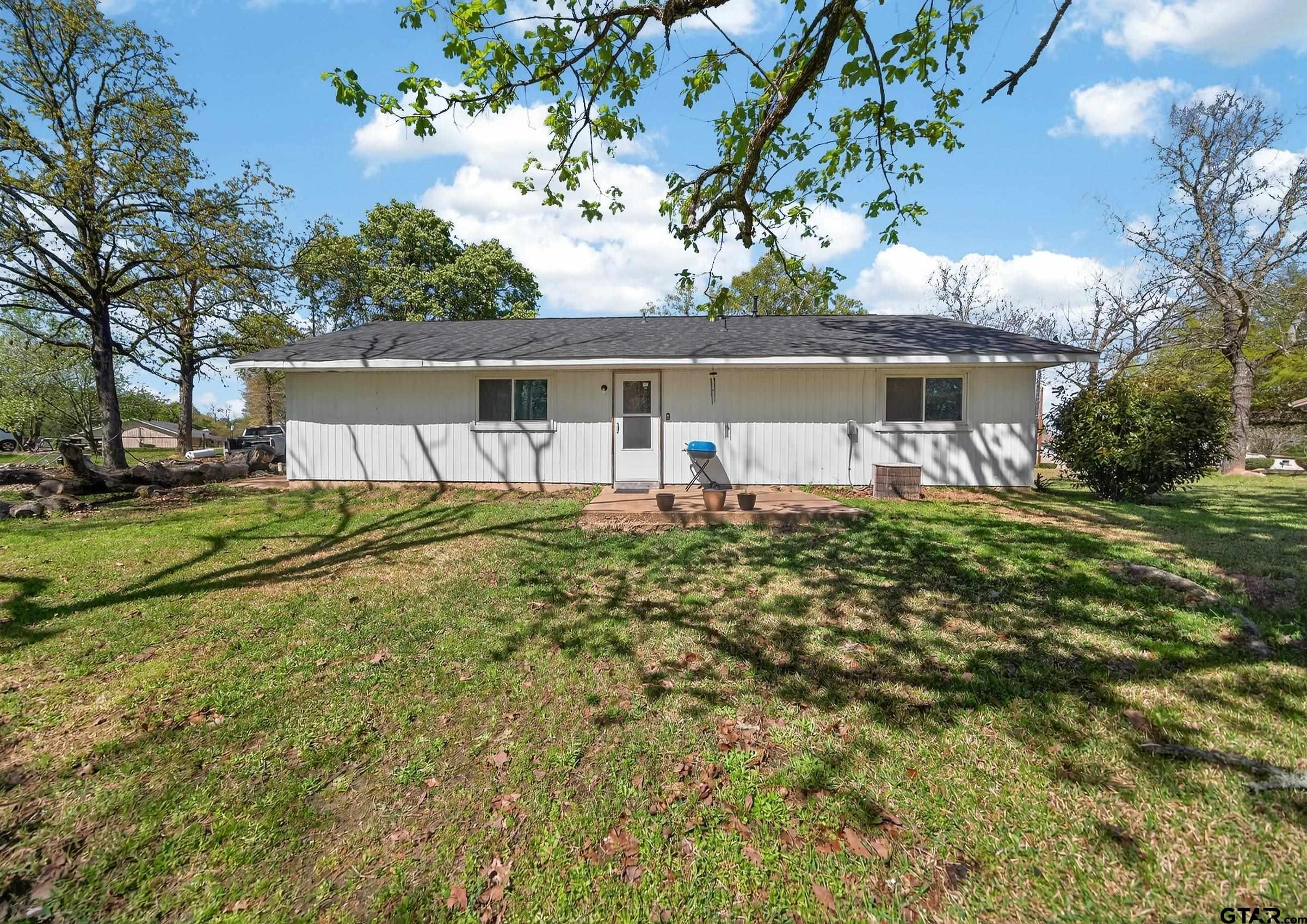 3165 Jackson Avenue Tyler, TX 75705 - Photo 23 of 24 a view of house with backyard and seating area