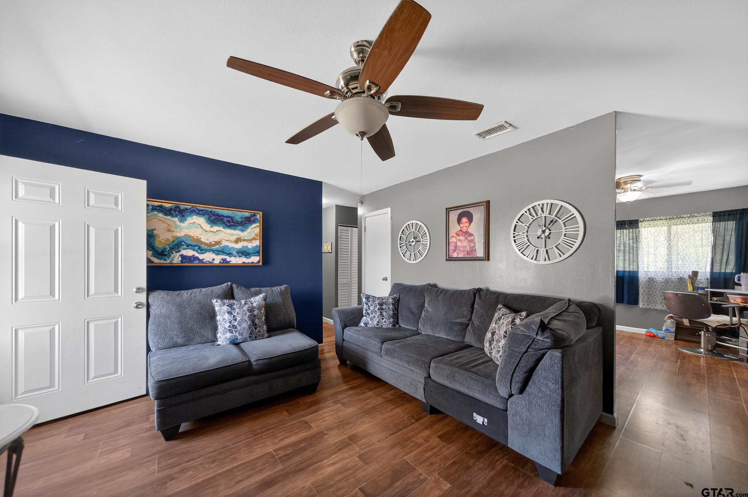 3165 Jackson Avenue Tyler, TX 75705 - Photo 5 of 24 a living room with furniture and a clock