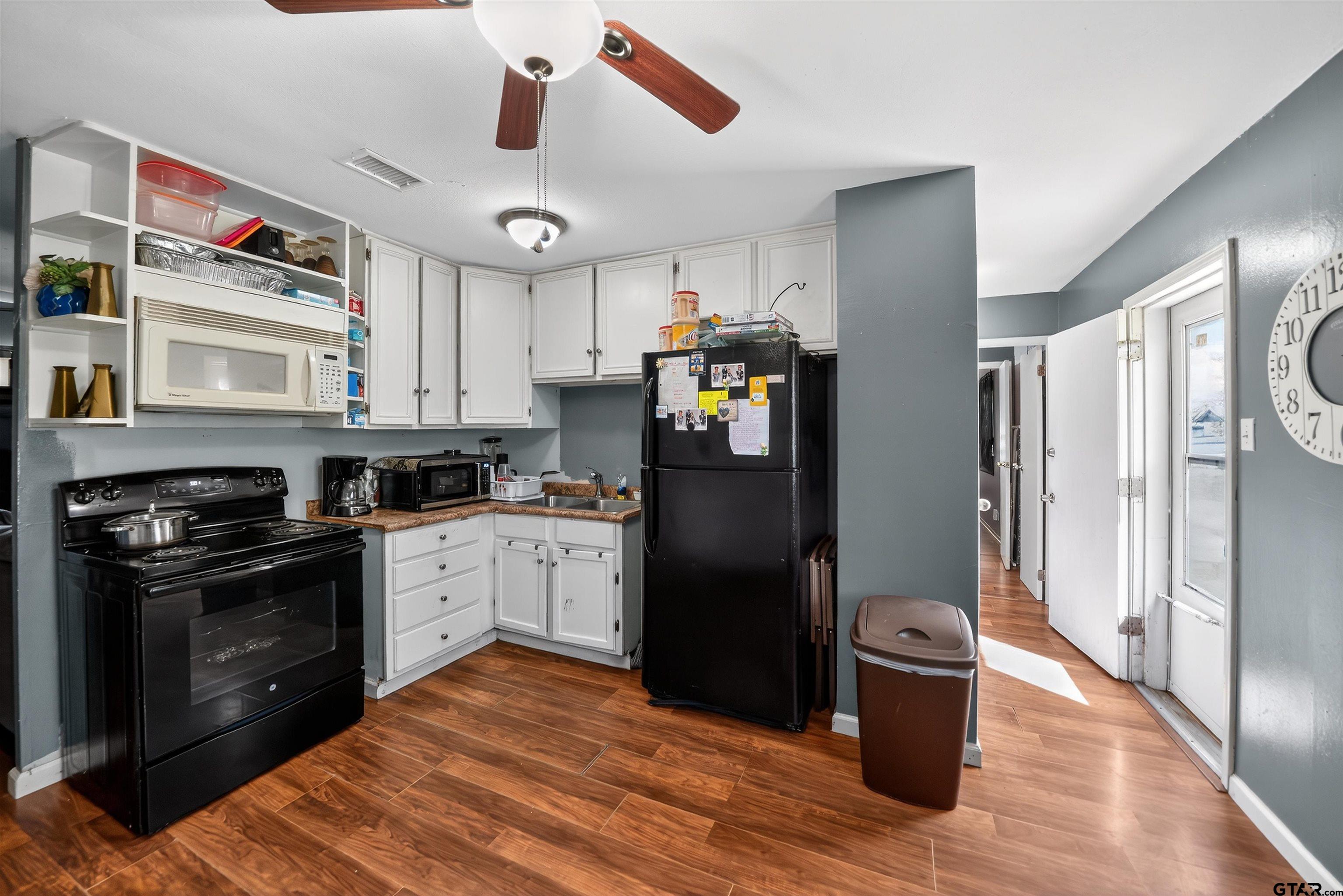 3165 Jackson Avenue Tyler, TX 75705 - Photo 7 of 24 a kitchen with stainless steel appliances granite countertop a refrigerator a stove and a cabinets