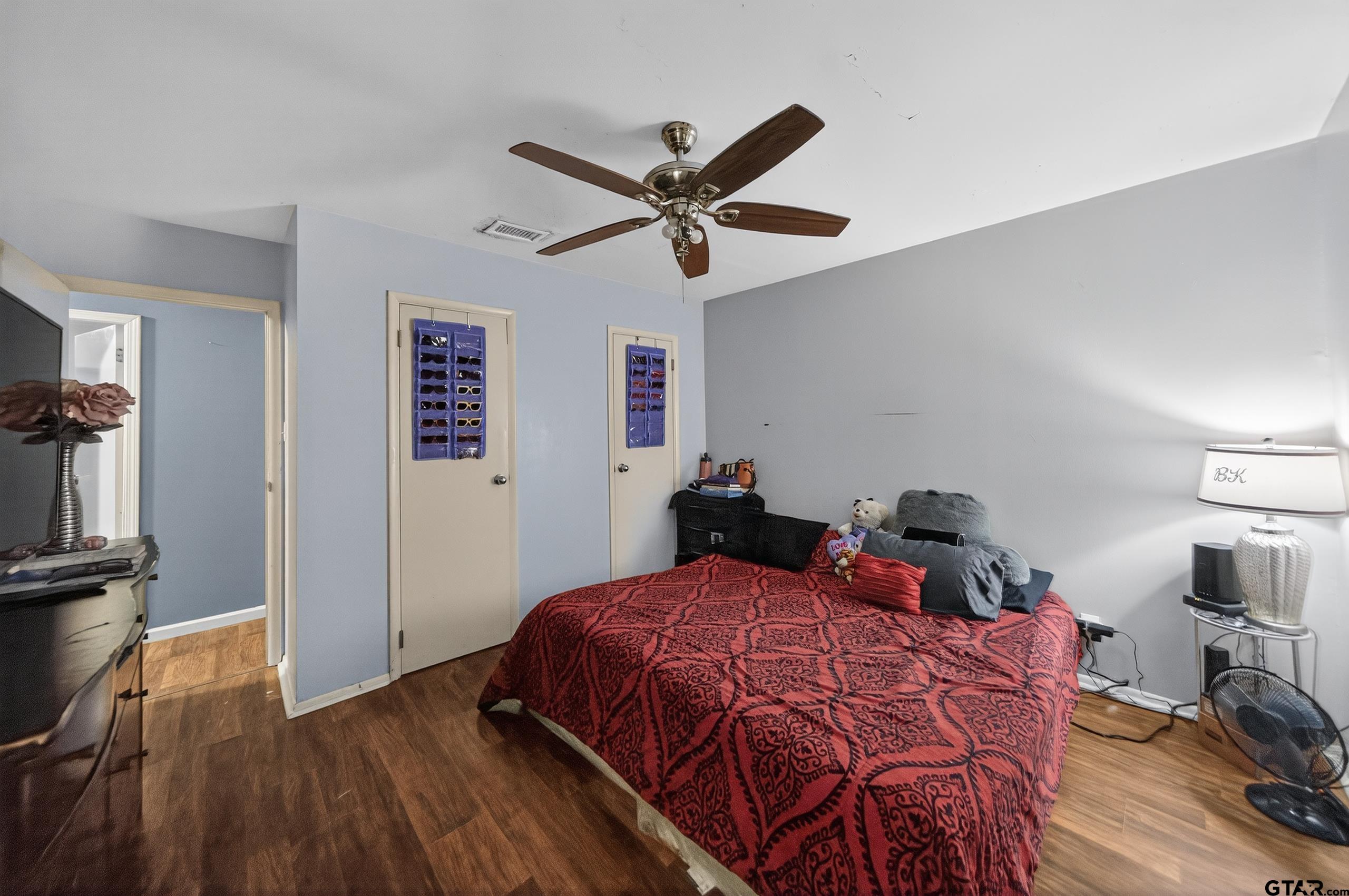 3165 Jackson Avenue Tyler, TX 75705 - Photo 8 of 24 a bed room with a bed and a ceiling fan