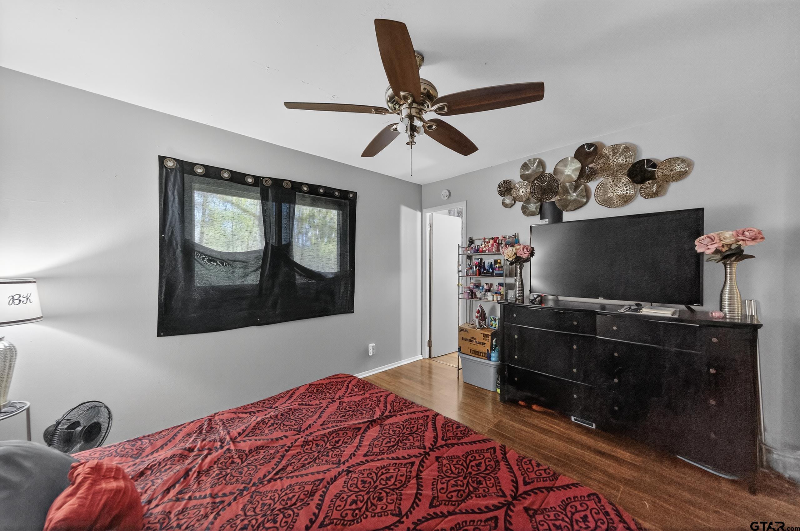3165 Jackson Avenue Tyler, TX 75705 - Photo 9 of 24 a bedroom with a bed and a dresser