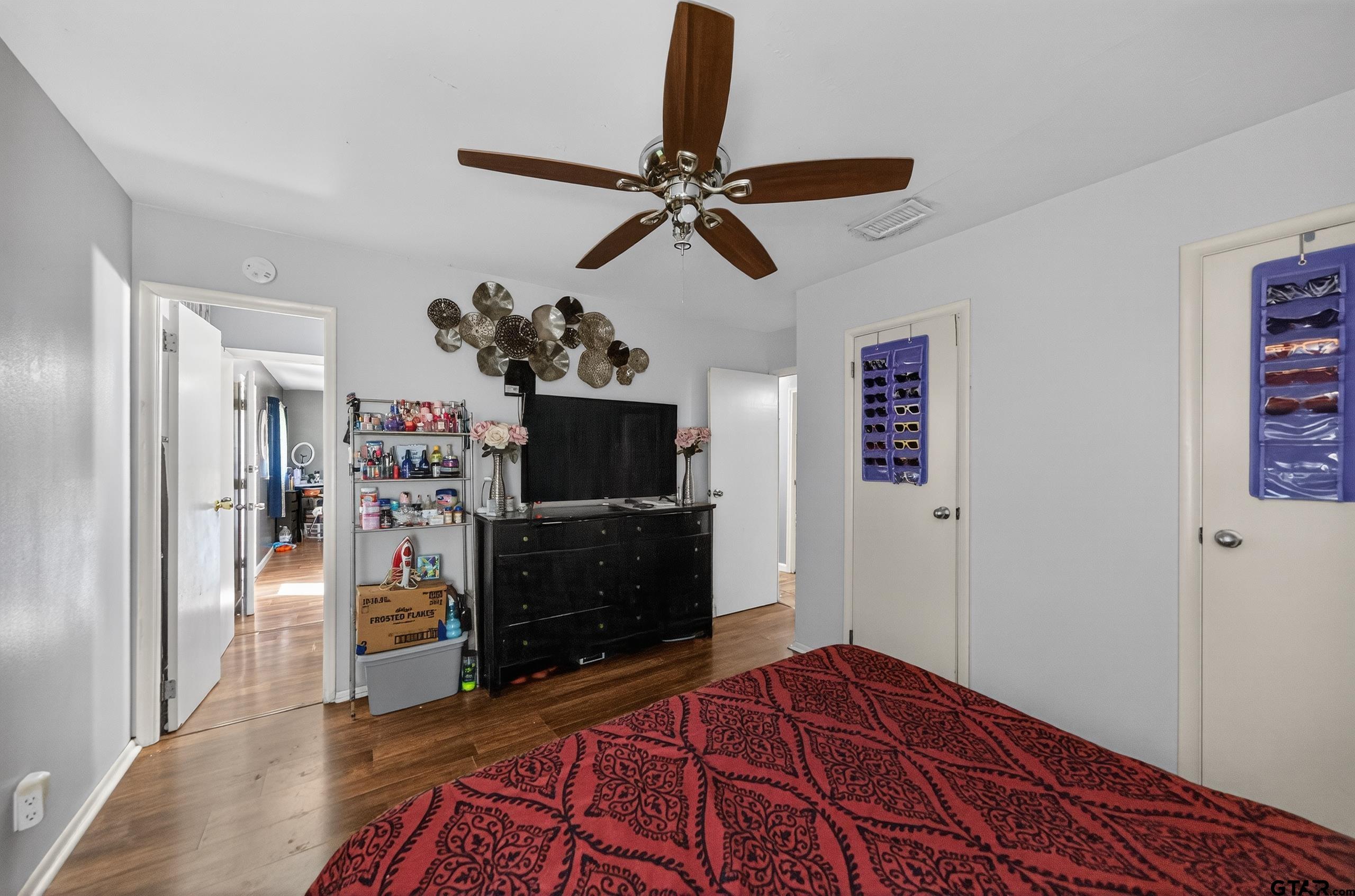 3165 Jackson Avenue Tyler, TX 75705 - Photo 10 of 24 a bedroom with a bed and a television