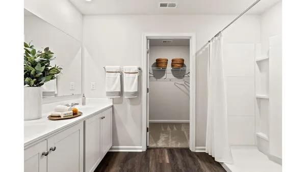 a storage room with wooden floor and cabinets