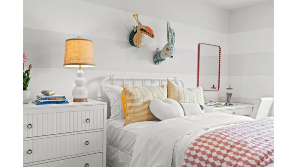 a bedroom with a bed and a lamp