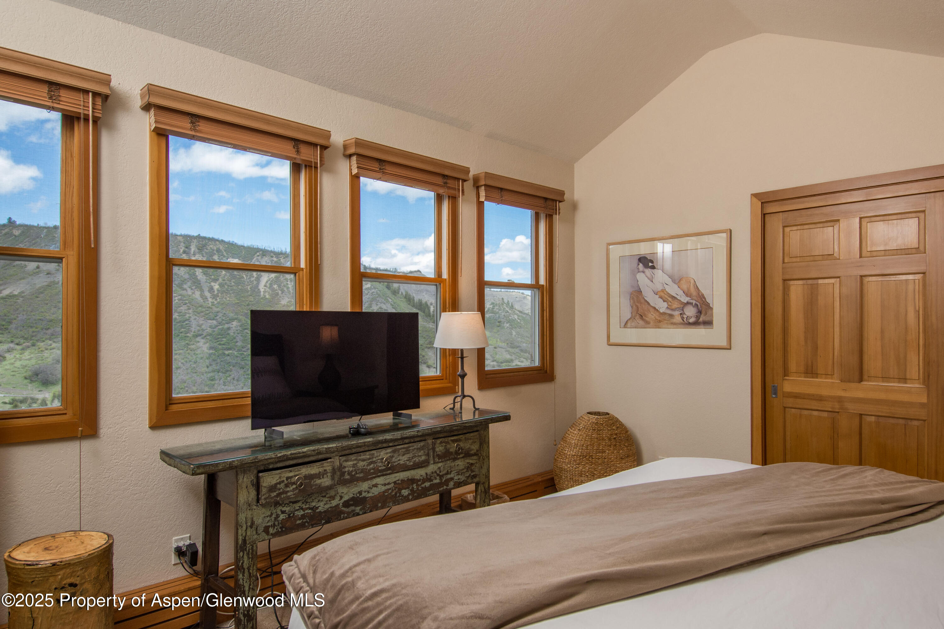 425 Wood Road, Unit 48 Snowmass Village, CO 81615 - Photo 20 of 39 a bedroom with a bed and a flat screen tv