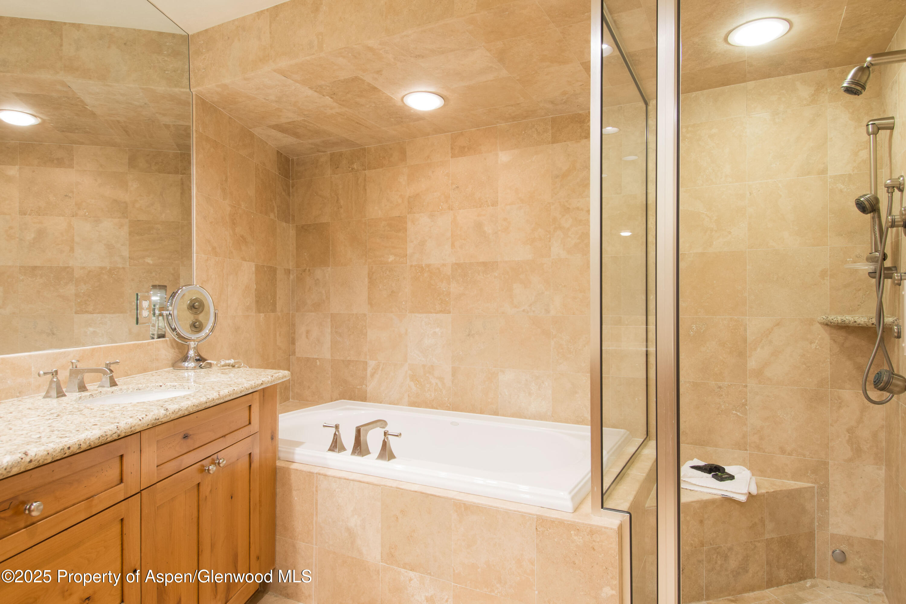 425 Wood Road, Unit 48 Snowmass Village, CO 81615 - Photo 21 of 39 a bathroom with a granite countertop sink a mirror and a bathtub