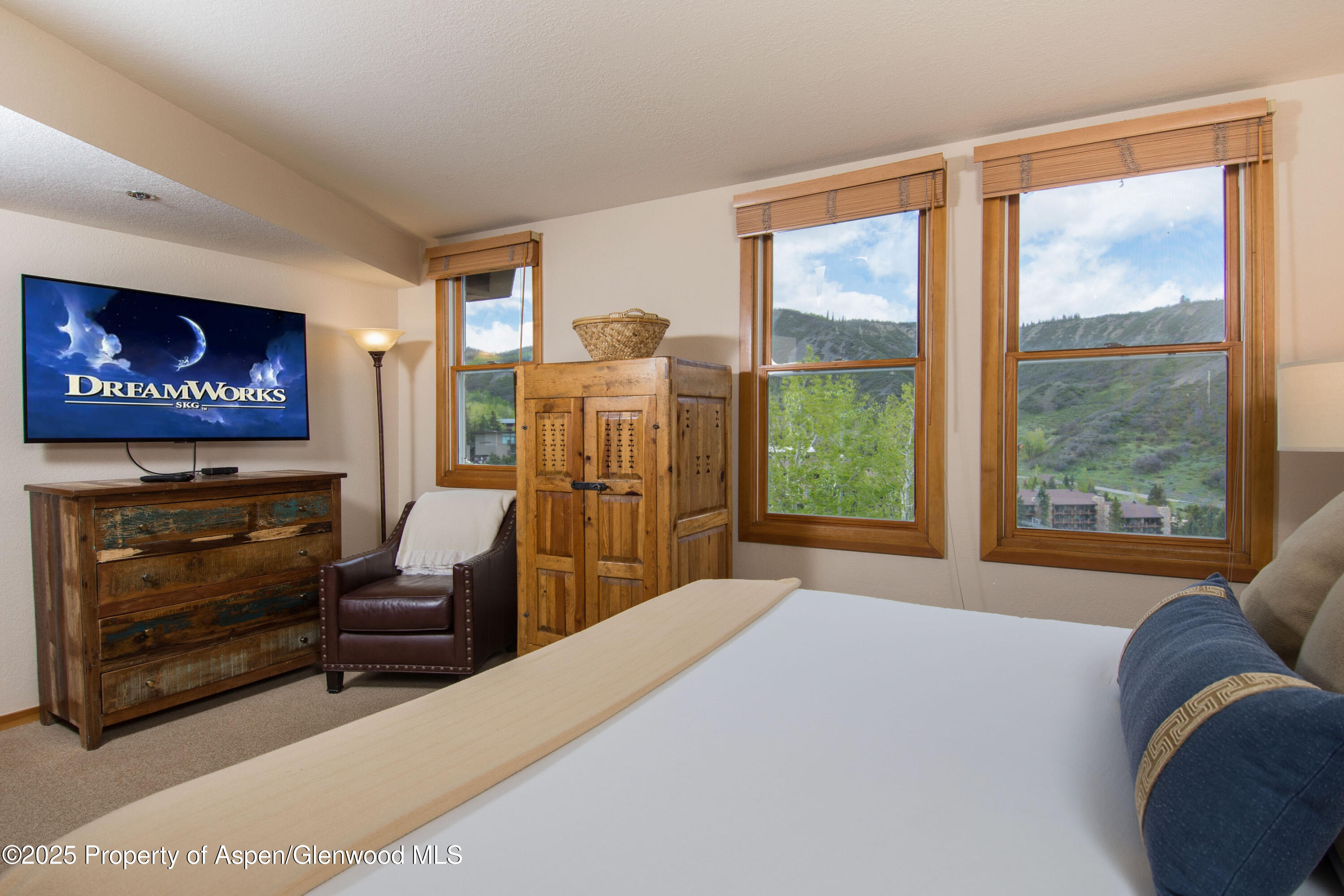 425 Wood Road, Unit 48 Snowmass Village, CO 81615 - Photo 26 of 39 a bed room with furniture and a fireplace