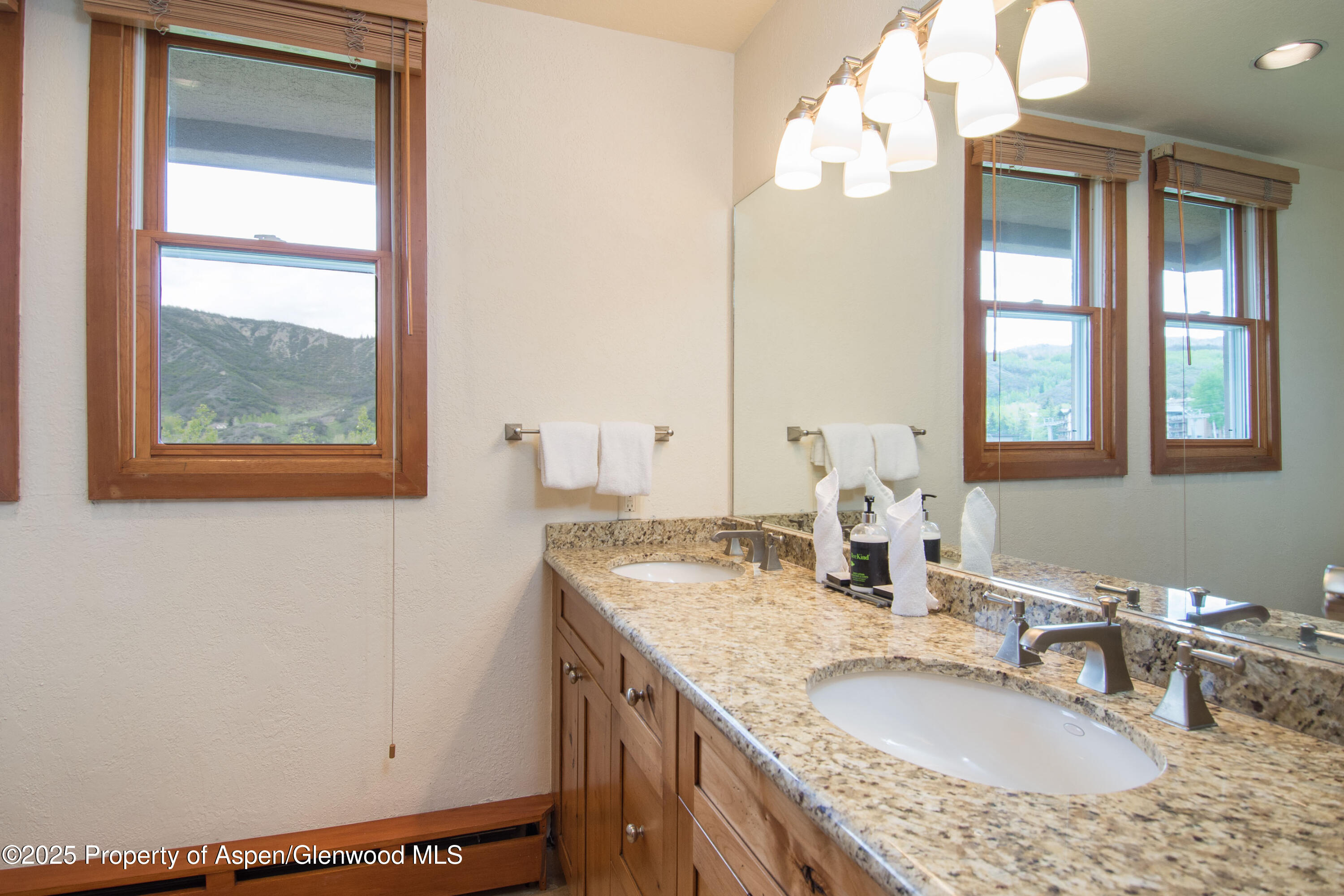 425 Wood Road, Unit 48 Snowmass Village, CO 81615 - Photo 27 of 39 a bathroom with a granite countertop sink and a mirror