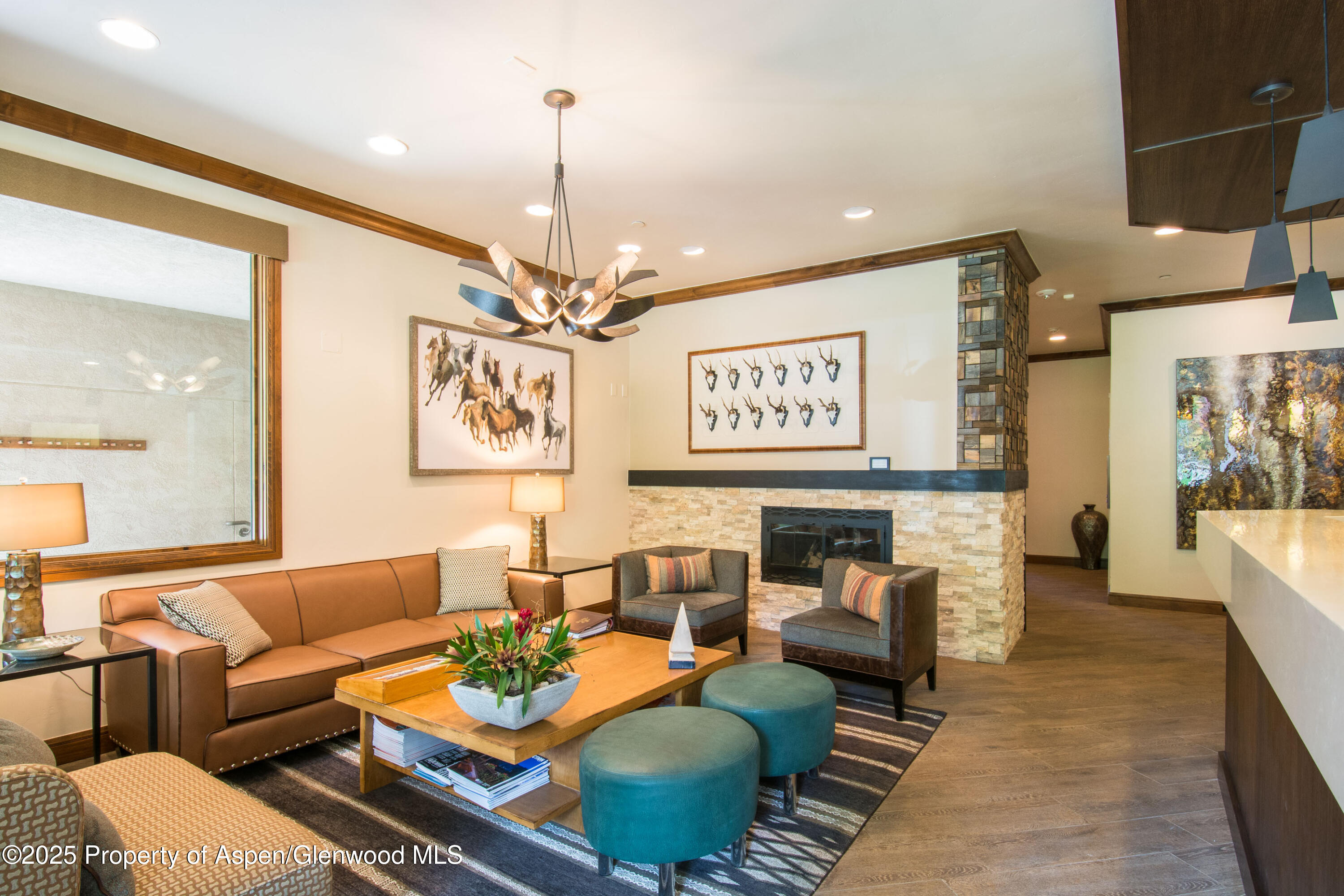 425 Wood Road, Unit 48 Snowmass Village, CO 81615 - Photo 39 of 41 a living room with furniture and a chandelier