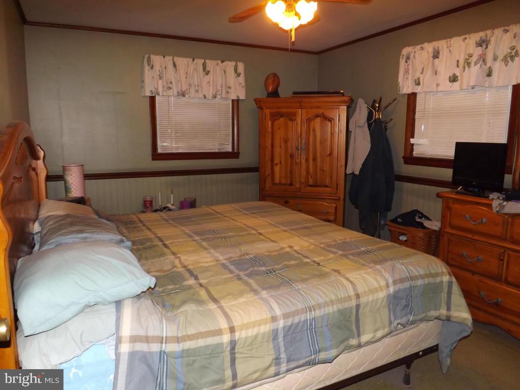 624 Snyder Road Lititz, PA 17543 - Photo 16 of 26 a bedroom with a bed and a flat tv screen on dresser