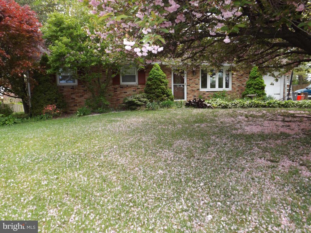 624 Snyder Road Lititz, PA 17543 - Photo 4 of 26 a front view of a house with a garden and trees