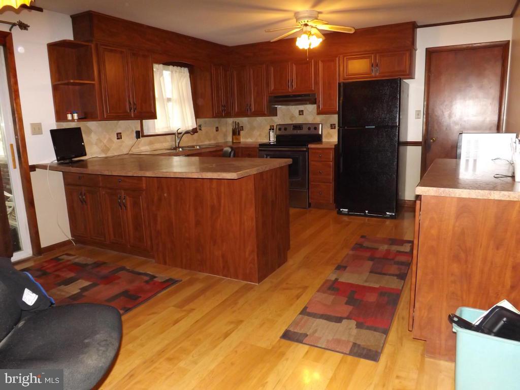 624 Snyder Road Lititz, PA 17543 - Photo 8 of 26 a kitchen with stainless steel appliances a stove a sink a refrigerator and cabinets