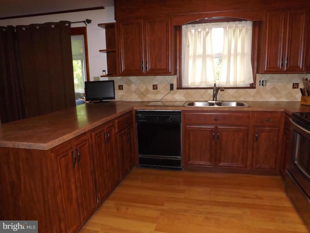 624 Snyder Road Lititz, PA 17543 - Photo 9 of 26 a kitchen with stainless steel appliances granite countertop a sink stove and refrigerator