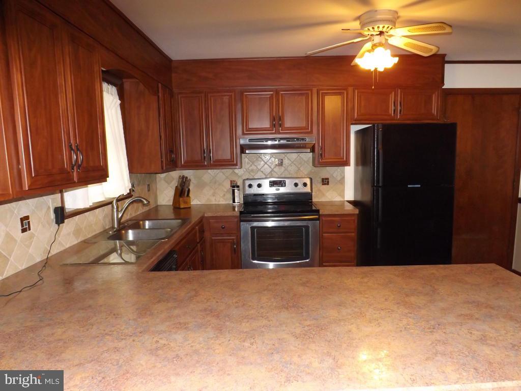 624 Snyder Road Lititz, PA 17543 - Photo 10 of 26 a kitchen with stainless steel appliances granite countertop a refrigerator a stove a sink and a microwave